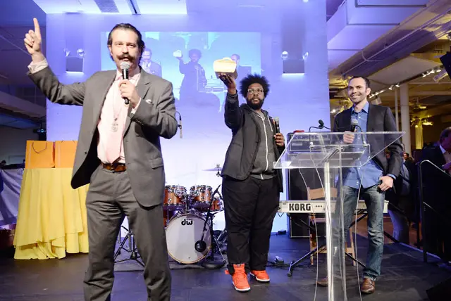 Questlove holding Cronuts with Dominique Ansel on the right and auctioneer Nicho Lowry on the left